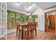 Bright breakfast room features multiple windows, hardwood floors, and modern chandelier at 1850 Linnet Ne Ct, Roswell, GA 30075