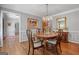 Charming dining room with a chandelier, hardwood floors, and a wooden table set for four at 1850 Linnet Ne Ct, Roswell, GA 30075