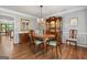 Elegant dining room featuring hardwood floors, a chandelier, a large mirror, and wooden table set for six at 1850 Linnet Ne Ct, Roswell, GA 30075