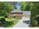 A brick two story home with a well manicured front yard and a two car garage at 1850 Linnet Ne Ct, Roswell, GA 30075