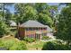 A beautiful brick home with a lush green lawn, mature landscaping, and a two-car garage at 1850 Linnet Ne Ct, Roswell, GA 30075