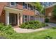 Beautiful brick home featuring a manicured front yard and a covered entryway with an elegant double door at 1850 Linnet Ne Ct, Roswell, GA 30075