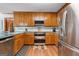 The kitchen features wood cabinets, tile backsplash, stainless steel appliances, and hardwood floors at 1850 Linnet Ne Ct, Roswell, GA 30075