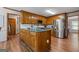 Spacious kitchen features custom wood cabinetry, stainless steel appliances, and hardwood floors at 1850 Linnet Ne Ct, Roswell, GA 30075