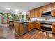 Bright kitchen featuring wood cabinets, stainless steel appliances, hardwood floors, and a breakfast nook at 1850 Linnet Ne Ct, Roswell, GA 30075