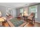 Bright living room featuring hardwood floors, two windows, and two stylish chairs with side table at 1850 Linnet Ne Ct, Roswell, GA 30075