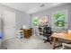 Bright office with functional desk and sewing machine, great natural light at 1850 Linnet Ne Ct, Roswell, GA 30075
