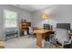 Functional office space with built-in desk, bookcase, and natural light from window at 1850 Linnet Ne Ct, Roswell, GA 30075