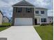 Two-story home boasts brick and siding, a two-car garage, and a well-manicured front yard at 173 Aster Ave, Locust Grove, GA 30248