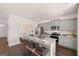 Contemporary kitchen island with seating and stainless steel appliances at 173 Aster Ave, Locust Grove, GA 30248