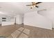 Open-concept living room with wood floors, a kitchen, and ample natural light at 173 Aster Ave, Locust Grove, GA 30248