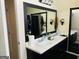 Bathroom featuring double sinks and large framed mirror at 5814 Highgrove Dr, Atlanta, GA 30349