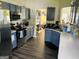 Well-lit kitchen featuring stainless steel appliances, tile backsplash, and gray cabinets at 5814 Highgrove Dr, Atlanta, GA 30349
