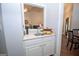 Wet bar with a sink and storage, perfect for entertaining, sits between the kitchen and dining area at 832 Windy Mill Ct, Temple, GA 30179