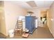 Basement storage area with blue cabinet, mini-fridge, and various household items at 832 Windy Mill Ct, Temple, GA 30179