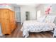Cozy bedroom with hardwood floors, natural light, and a floral-patterned comforter, offering a peaceful retreat at 832 Windy Mill Ct, Temple, GA 30179