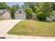 Well-manicured front lawn leads to a charming home with a convenient two-car garage at 832 Windy Mill Ct, Temple, GA 30179