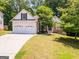 Charming home featuring a two-car garage, stone accents, and well-maintained front yard at 832 Windy Mill Ct, Temple, GA 30179