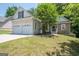 Charming home featuring a two-car garage, stone accents, and well-maintained front yard at 832 Windy Mill Ct, Temple, GA 30179