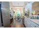 Bright eat-in kitchen features stainless steel appliances, white cabinetry, and a sun-filled breakfast nook at 832 Windy Mill Ct, Temple, GA 30179