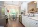 Bright eat-in kitchen features stainless steel appliances, white cabinetry, and a sun-filled breakfast nook at 832 Windy Mill Ct, Temple, GA 30179