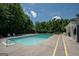 Community swimming pool area with ample lounge chairs and a paved deck at 832 Windy Mill Ct, Temple, GA 30179