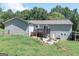 Spacious backyard with a wooden deck, fire pit area, and well-maintained lawn at 8321 Banks Mill Rd, Douglasville, GA 30135