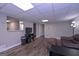 This finished basement features a leather sofa, wood floors, and a tv at 8321 Banks Mill Rd, Douglasville, GA 30135