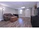 This finished basement features a leather sofa, wood floors, a tv, and a door to the outside at 8321 Banks Mill Rd, Douglasville, GA 30135