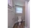 This small bathroom features a toilet and a wall rack for hanging towels at 8321 Banks Mill Rd, Douglasville, GA 30135
