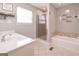 This bathroom has a shower, tub, and single sink with cream colored countertops at 8321 Banks Mill Rd, Douglasville, GA 30135