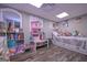 Charming bedroom with hardwood floors, plush toys, and ample play space at 8321 Banks Mill Rd, Douglasville, GA 30135