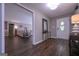Spacious entryway with gleaming hardwood floors, a decorative mirror, stylish lighting, and a glimpse into the cozy living area at 8321 Banks Mill Rd, Douglasville, GA 30135