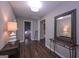 Inviting entryway with sleek dark hardwood floors, complemented by modern lighting, decor, and a stylish mirror at 8321 Banks Mill Rd, Douglasville, GA 30135