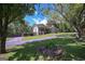 Charming home with a long driveway, porte-cochere, and partial stone chimney, all set in a green, tree-filled landscape at 8321 Banks Mill Rd, Douglasville, GA 30135