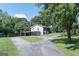 Exterior view of a home with an attached carport and spacious driveway at 8321 Banks Mill Rd, Douglasville, GA 30135