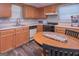 This kitchen has wood cabinets, laminate floors, and stainless steel appliances at 8321 Banks Mill Rd, Douglasville, GA 30135