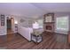 Comfortable living room featuring a stone fireplace, hardwood floors, neutral walls, and ample seating at 8321 Banks Mill Rd, Douglasville, GA 30135