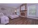 Inviting living room with a stone fireplace, hardwood floors, natural light, and an oversized, comfortable sofa at 8321 Banks Mill Rd, Douglasville, GA 30135