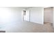 Bright bedroom with neutral carpet, white walls, and walk-in closet offering a serene and comfortable space at 609 Lobelia Way, Locust Grove, GA 30248