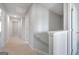 Upstairs hallway with carpet, white trim, and doors leading to bedrooms and bathrooms at 609 Lobelia Way, Locust Grove, GA 30248