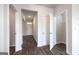 Hallway with hardwood floors and neutral paint, leading to the front door and a closet at 609 Lobelia Way, Locust Grove, GA 30248