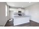 Bright kitchen featuring an island, granite countertops, stainless steel appliances, and white cabinetry at 609 Lobelia Way, Locust Grove, GA 30248