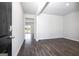 Open concept living room with hardwood floors and neutral paint colors at 609 Lobelia Way, Locust Grove, GA 30248
