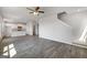 Open concept living room flows into a white kitchen and features hardwood flooring and staircase at 609 Lobelia Way, Locust Grove, GA 30248