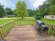 Spacious back deck with wooded views features a barbecue grill and ample room for entertaining at 5141 Hiram Lithia Springs Rd, Powder Springs, GA 30127
