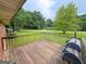 View from the back deck looking to yard and a street with mature trees in the background at 5141 Hiram Lithia Springs Rd, Powder Springs, GA 30127