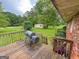View of the back deck with stairs, outdoor grill, shed, and tree-lined yard at 5141 Hiram Lithia Springs Rd, Powder Springs, GA 30127