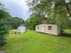 Lush backyard with outbuildings and a picnic area, providing a relaxing outdoor space at 5141 Hiram Lithia Springs Rd, Powder Springs, GA 30127