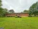 Spacious backyard with a well-kept lawn and a charming deck, perfect for outdoor entertainment at 5141 Hiram Lithia Springs Rd, Powder Springs, GA 30127
